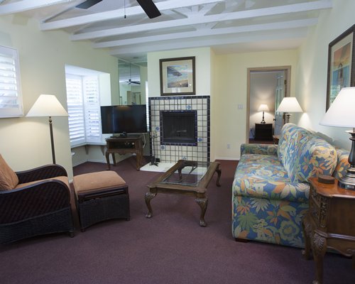 A well furnished living room with a fireplace and a television.
