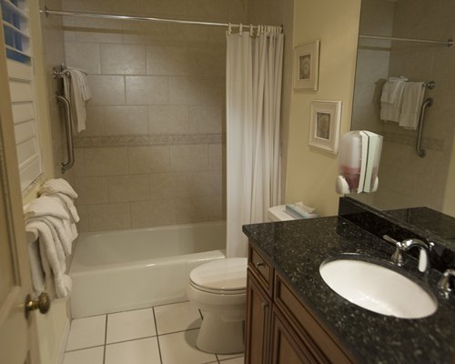 A bathroom with bathtub and sink vanity.