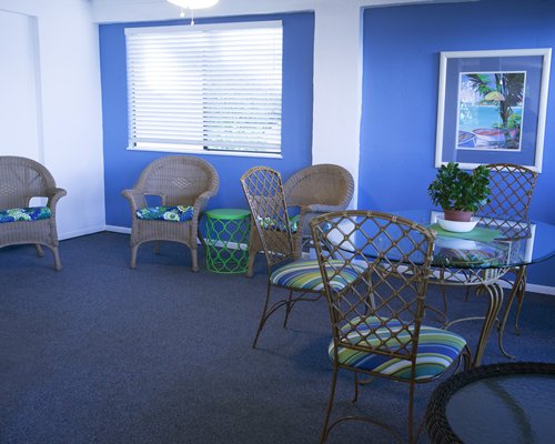 Furnished living room with glass top dining area.