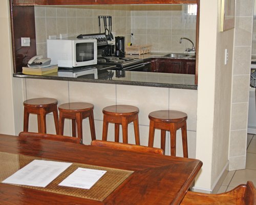 View of dining area alongside a kitchen with breakfast bar.