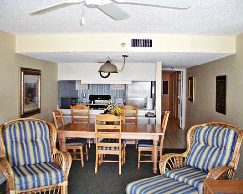 A well furnished living and dining area alongside kitchen.