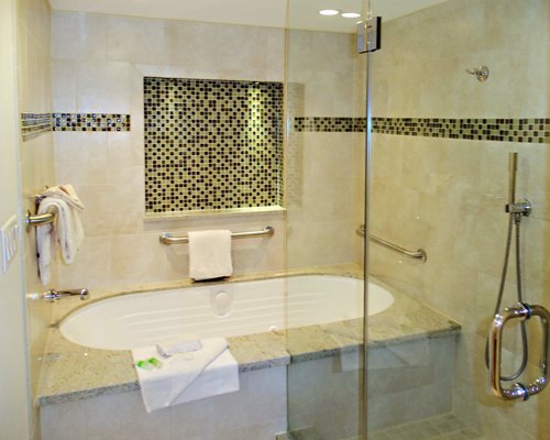 A bathroom with a bath tub and shower.