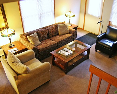 A well furnished living room with pullout sofas.