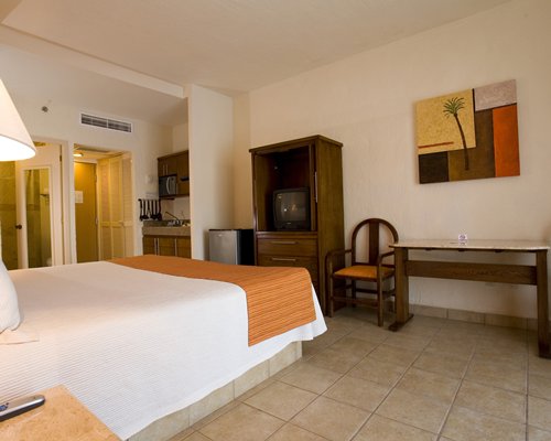 A well furnished living room with a dining area and outdoor view of swimming pool.