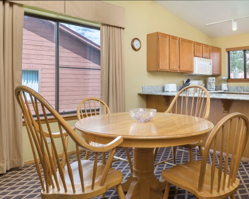 A WELL FURNISHED DINING AREA ALONGSIDE THE KITCHEN WITH AN OUTSIDE VIEW.