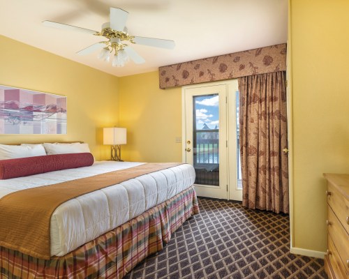 A WELL FURNISHED BEDROOM WITH BALCONY.