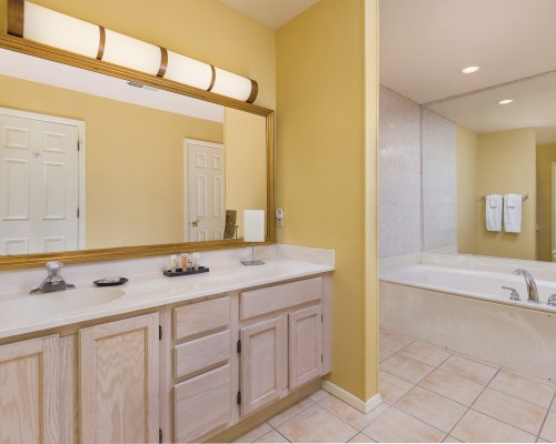 A BATHROOM WITH A BATHTUB SHOWER AND SINGLE SINK VANITY.