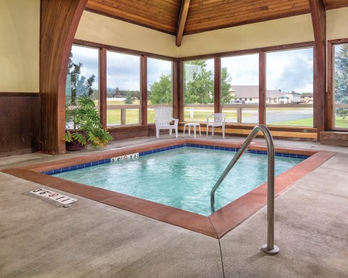 AN INDOOR HOT TUB WITH OUTSIDE VIEW.