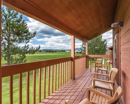 OUTDOOR PATIO WITH PATIO CHAIRS AND SCENIC LANDSCAPE.