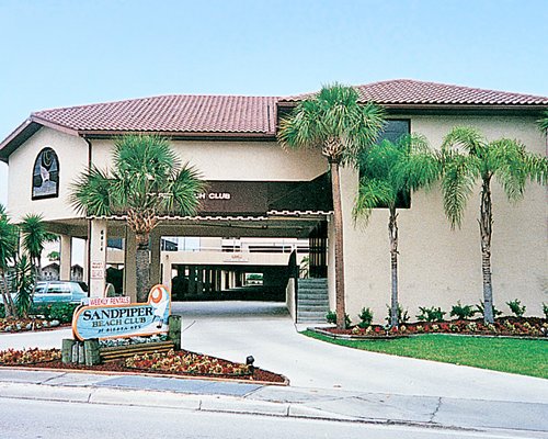 An exterior view of Sandpiper Beach Club resort with its signboard.