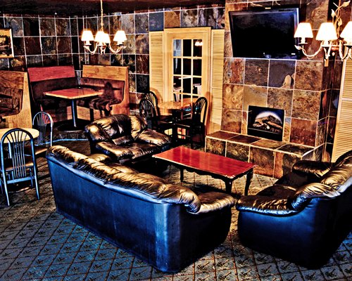 An open plan living room with a fireplace television and dining area.