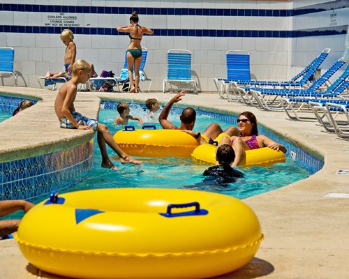An outdoor swimming pool with chaise lounge chairs.