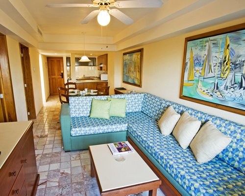 An open plan furnished living room with dining area and a patio.