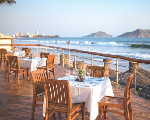 An exterior view of a fine dining restaurant facing the water.