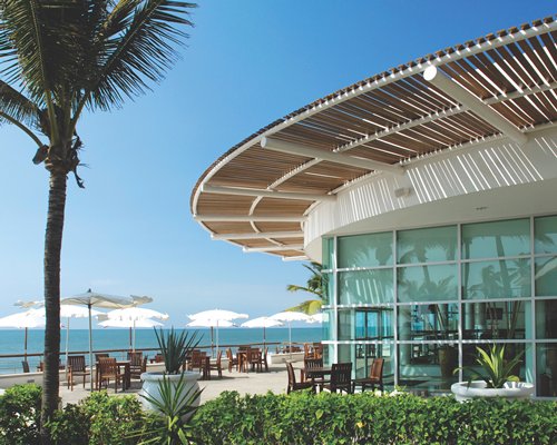An exterior view of the resort alongside the ocean.