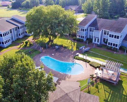 An aerial view of resort units with an outdoor swimming pool.