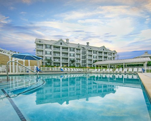 A view of resort with large pool and patio area.