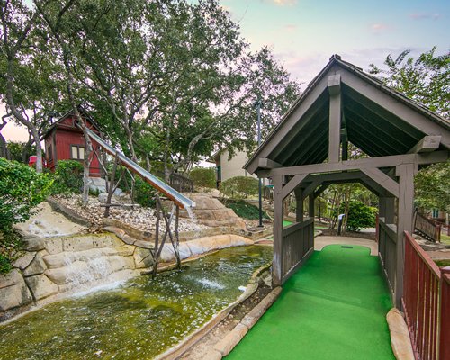 Scenic miniature golf area with water effects.