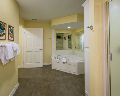 A bathroom with a shower bathtub and single sink vanity.