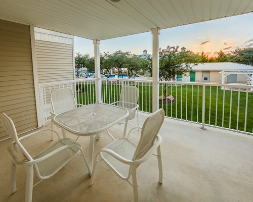 Balcony table seating overlooking pool area.