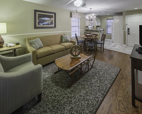 An open plan living room with kitchen and dining area.