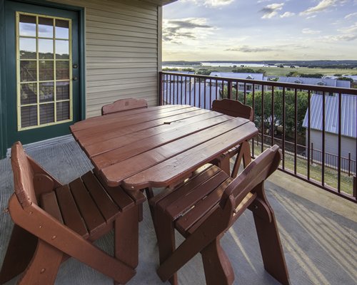 Balcony table seating overlooking scenic resort and area.