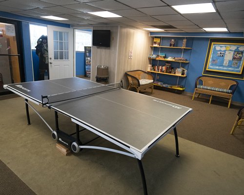 An indoor recreation room with ping pong