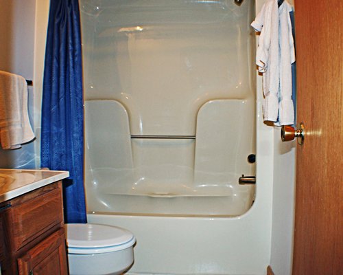 A bathroom with bathtub and shower.