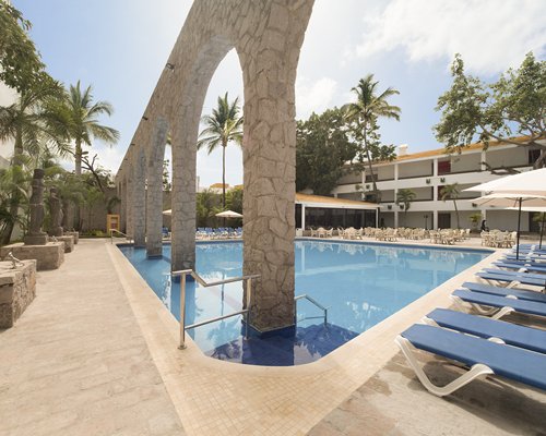 Outdoor swimming pool with chaise lounge chairs.