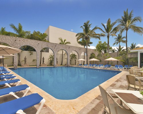 An outdoor swimming pool with sculptures.