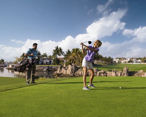A couple playing golf.