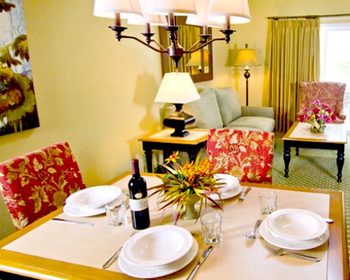 AN OPEN PLAN LIVING ROOM WITH DINING TABLE.