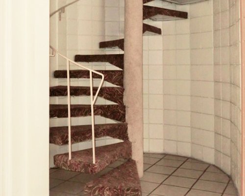 A view of an indoor spiral stairway.