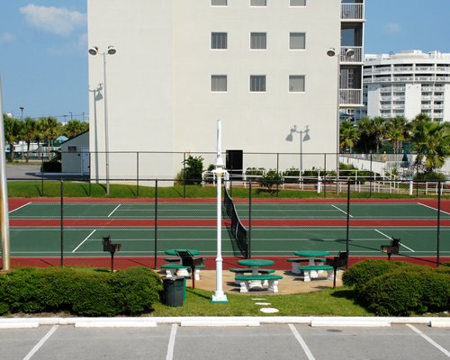 A tennis court alongside picnic area.