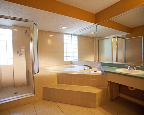 A bathroom with shower bathtub and shower stall.