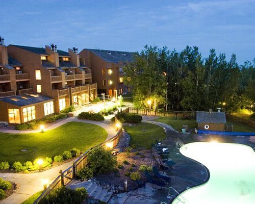 Scenic view of an outdoor swimming pool alongside multi story resort units.