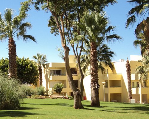 An exterior view of resort units with trees.