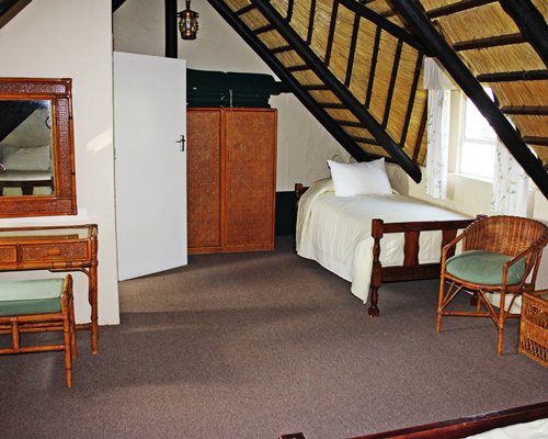 A well furnished bedroom with a single bed.