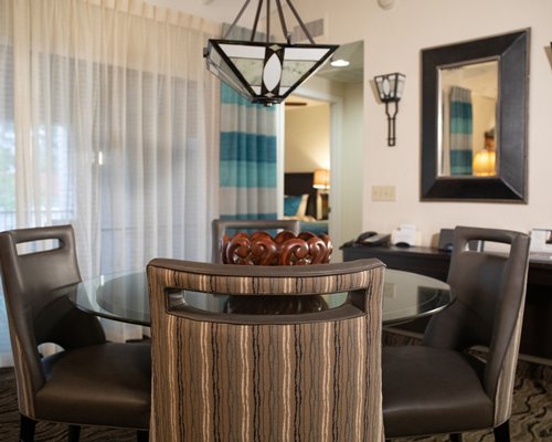 Balcony view of a living area with pull out sofas television and fire at the fireplace.