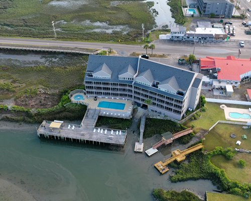 An exterior view of the Seawatch Landing resort alongside waterfront.