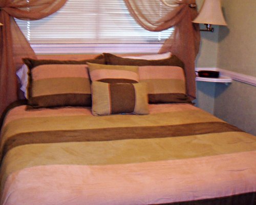 A well furnished bedroom with queen bed.