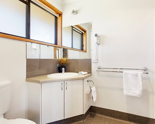 A bathroom with open sink vanity.