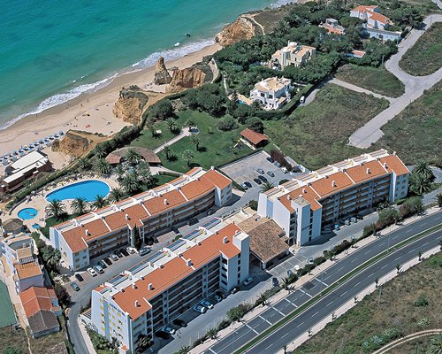 An aerial view of the Jardim do Vau resort alongside the ocean.