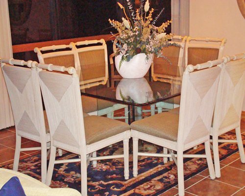 A well furnished glass topped dining area.