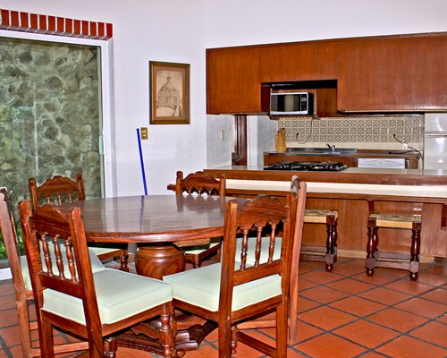 An open plan kitchen with breakfast bar and dining area.