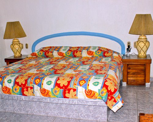A well furnished bedroom with a king bed.