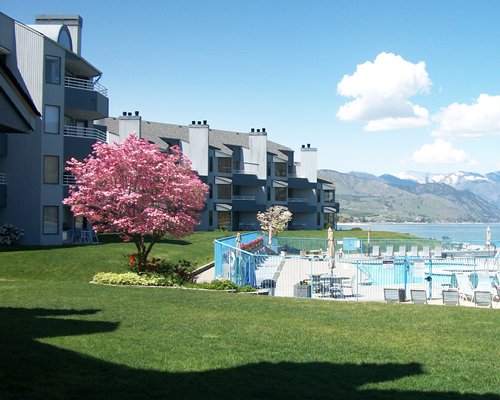 Exterior view of multiple unit balconies with an outdoor swimming pool.