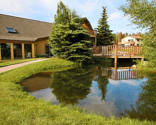 A scenic exterior view of Swan Mountain Resort alongside the waterfront.