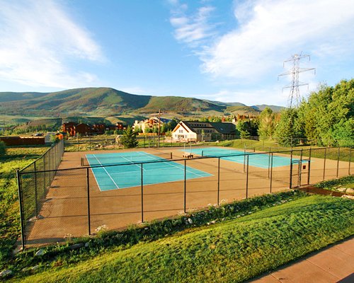 Outdoor recreation area with tennis court.