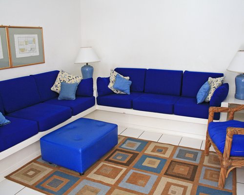 A well furnished living room with an ottoman.